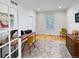 Cozy office space with hardwood floors, a classic desk, and a shuttered window at 7722 E 6Th Pl, Denver, CO 80230