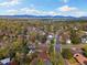 Scenic aerial view of a neighborhood with a backdrop of distant mountains and lush greenery at 10868 W 70Th Ave, Arvada, CO 80004
