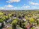 Expansive aerial view of a residential neighborhood, highlighting tree-lined streets and community layout at 10868 W 70Th Ave, Arvada, CO 80004