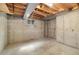 Unfinished basement has concrete walls, a small window, and exposed ceiling joists at 10868 W 70Th Ave, Arvada, CO 80004