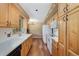 Functional kitchen with white appliances, wood cabinets, and hardwood floors at 10868 W 70Th Ave, Arvada, CO 80004