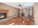 Comfortable living room with hardwood floors, a brick fireplace, and a ceiling fan at 10868 W 70Th Ave, Arvada, CO 80004