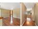Bright living room with hardwood floors and open doorway to dining area with natural light at 10868 W 70Th Ave, Arvada, CO 80004