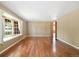 Open living room featuring hardwood floors and a large bay window offering plenty of natural light at 10868 W 70Th Ave, Arvada, CO 80004