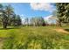 Scenic view of a lush green park with mature trees, a playground, and a sprawling lawn at 10868 W 70Th Ave, Arvada, CO 80004