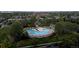 Community pool surrounded by trees, lawn chairs, and umbrellas at 2334 Yosemite St, Denver, CO 80238