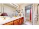 Bathroom with double sinks, wooden cabinets, and a full bath at 2334 Yosemite St, Denver, CO 80238