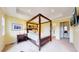 Spacious bedroom featuring a four-poster bed, tray ceiling, and ample natural light at 2334 Yosemite St, Denver, CO 80238