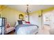 Inviting bedroom with a decorative chandelier, soft colors, and stylish furnishings at 2334 Yosemite St, Denver, CO 80238