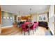 This dining room features a wood floor, table and chairs, and modern lighting at 2334 Yosemite St, Denver, CO 80238