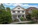 Charming two-story home featuring a welcoming front porch and beautiful landscaping at 2334 Yosemite St, Denver, CO 80238