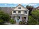 Inviting two-story home boasting a covered front porch, classic design, and well-maintained yard at 2334 Yosemite St, Denver, CO 80238
