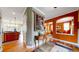 Warm foyer featuring hardwood floors, a decorative table, and views into adjacent living spaces at 2334 Yosemite St, Denver, CO 80238