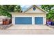 Two-car garage featuring blue doors at 2334 Yosemite St, Denver, CO 80238