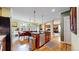 Open kitchen and dining area with stainless steel appliances and hardwood floors at 2334 Yosemite St, Denver, CO 80238