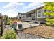 This home has a lovely back patio area with rock accents and potted flowers, perfect for enjoying the outdoors at 5045 Preserve Pl, Firestone, CO 80504