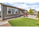 Backyard with artificial turf, privacy fence and patio furniture at 5045 Preserve Pl, Firestone, CO 80504