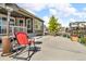 Backyard patio area with furniture and an outdoor heater and view of the street at 5045 Preserve Pl, Firestone, CO 80504