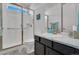 Bathroom with glass enclosed shower, tile floors, toilet, sink and vanity with light marble countertops at 5045 Preserve Pl, Firestone, CO 80504