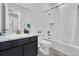 Bathroom featuring a shower with curtain and bath tub, toilet and vanity with dark cabinets and marble countertops at 5045 Preserve Pl, Firestone, CO 80504