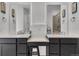 Bright bathroom featuring double sinks, white countertops and dark cabinets at 5045 Preserve Pl, Firestone, CO 80504