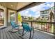Relax on this home's covered porch with rocking chairs and enjoy neighborhood views at 5045 Preserve Pl, Firestone, CO 80504
