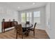 Comfortable dining area with a round wood table, seating for four, and bright natural light at 5045 Preserve Pl, Firestone, CO 80504
