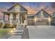 Charming two-story home with a stone accent, covered porch, manicured lawn and two-car garage at 5045 Preserve Pl, Firestone, CO 80504