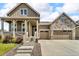 Charming home with stone accents, a welcoming porch, and a two-car garage at 5045 Preserve Pl, Firestone, CO 80504