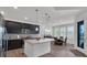 Bright kitchen with dark cabinetry, stainless appliances, a center island, and an adjacent dining space at 5045 Preserve Pl, Firestone, CO 80504
