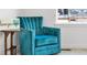 A cozy blue chair with a small wooden table and decorative heart accent at 5045 Preserve Pl, Firestone, CO 80504