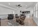 Open-concept living room with hardwood floors, plush seating, and a clear view of the modern kitchen at 5045 Preserve Pl, Firestone, CO 80504