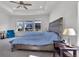 Bright main bedroom with tray ceiling, large windows, and a blue bedspread at 5045 Preserve Pl, Firestone, CO 80504