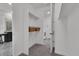 Walk-in closet with shelving and carpet, next to the laundry room and bathroom at 5045 Preserve Pl, Firestone, CO 80504