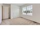 A bright bedroom featuring a large window, closet and plush carpet flooring at 21935 E 39Th Pl, Aurora, CO 80019