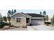 Charming single-story home featuring stone accents, a two-car garage, and professional landscaping at 21935 E 39Th Pl, Aurora, CO 80019