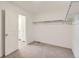 A spacious walk-in closet with an open door leading to the bathroom at 21935 E 39Th Pl, Aurora, CO 80019