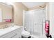 Clean bathroom with white vanity, toilet, and a glass-enclosed shower, offering a fresh and modern feel at 21062 E Mansfield Pl, Aurora, CO 80013