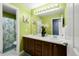Vibrant bathroom featuring a double vanity, sleek countertop, and a large mirror, offering a modern space at 21062 E Mansfield Pl, Aurora, CO 80013