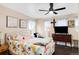 Cozy bedroom featuring a floral patterned bed, ceiling fan, and window, creating a relaxing atmosphere at 21062 E Mansfield Pl, Aurora, CO 80013