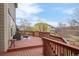 Inviting deck with outdoor seating, wood railings, and a view of the neighborhood and blue sky above at 21062 E Mansfield Pl, Aurora, CO 80013