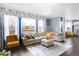 Spacious living room featuring a comfortable sofa, large windows, and a modern chandelier at 21062 E Mansfield Pl, Aurora, CO 80013