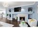 Bright living room with a fireplace, modern decor, and hardwood floors at 21062 E Mansfield Pl, Aurora, CO 80013