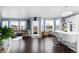 Open concept living space filled with natural light, hardwood floors, and access to the outdoor deck at 21062 E Mansfield Pl, Aurora, CO 80013