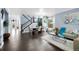 Spacious living area with hardwood floors, dining table, large windows, and modern decor at 21062 E Mansfield Pl, Aurora, CO 80013