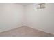 Finished basement with carpet flooring and a small window at 4638 S Mobile Way, Aurora, CO 80015