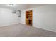 Finished basement with carpet flooring and built-in shelving at 4638 S Mobile Way, Aurora, CO 80015