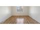 Bright, empty bedroom showcasing hardwood floors and natural light at 4638 S Mobile Way, Aurora, CO 80015