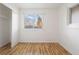 A bright bedroom with a closet and large window at 4638 S Mobile Way, Aurora, CO 80015