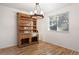 Bright dining area showcasing a vintage hutch, modern light fixture, hardwood flooring and natural light at 4638 S Mobile Way, Aurora, CO 80015